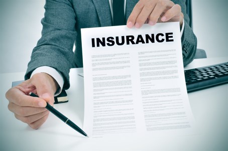 insurance adjuster pointing to insurance policy