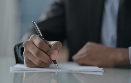 man writing in injury journal