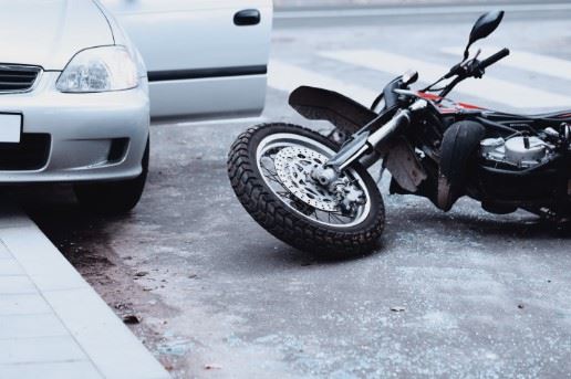 motorcycle laying in the road after a crash