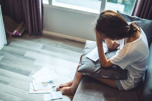 woman stressing over paying medical bills